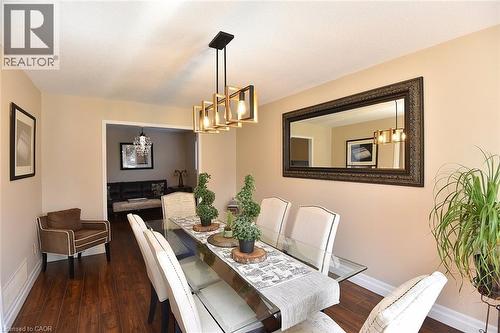 Dining room with dark wood finished floors and a chandelier - 2206 Donald Road, Burlington, ON - Indoor Photo Showing Dining Room
