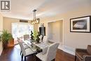 Dining area with a chandelier, dark wood-style flooring, and a textured ceiling - 2206 Donald Road, Burlington, ON  - Indoor Photo Showing Dining Room 