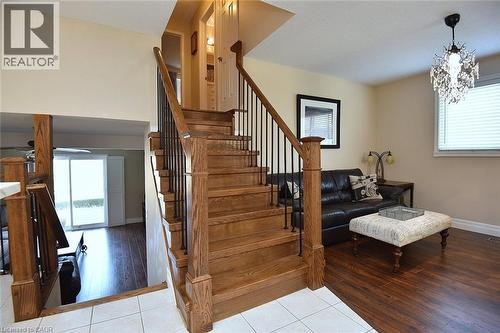 Staircase featuring healthy amount of natural light, hardwood / wood-style floors, and hanging lights - 2206 Donald Road, Burlington, ON - Indoor Photo Showing Other Room