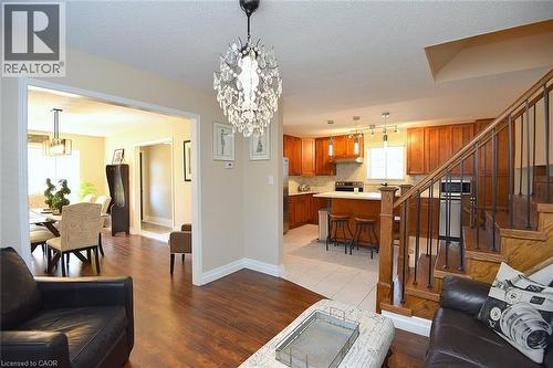 Living area featuring a chandelier, a textured ceiling, and light wood-type flooring - 2206 Donald Road, Burlington, ON - Indoor
