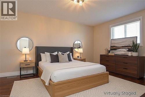 Bedroom featuring dark wood-type flooring and a textured ceiling - 2206 Donald Road, Burlington, ON - Indoor Photo Showing Bedroom