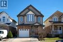 View of front of home with brick siding, an attached garage, concrete driveway, and covered porch - 126 Snowdrop Crescent, Kitchener, ON  - Outdoor With Deck Patio Veranda With Facade 