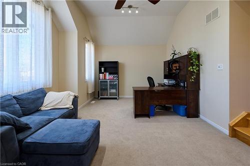 Home office featuring ceiling fan, light colored carpet, and lofted ceiling - 126 Snowdrop Crescent, Kitchener, ON - Indoor