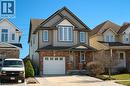 View of front of property with covered porch, a garage, concrete driveway, and brick siding - 126 Snowdrop Crescent, Kitchener, ON  - Outdoor With Facade 