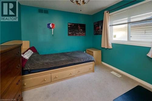 Carpeted bedroom with baseboards and a textured ceiling - 126 Snowdrop Crescent, Kitchener, ON - Indoor Photo Showing Bedroom