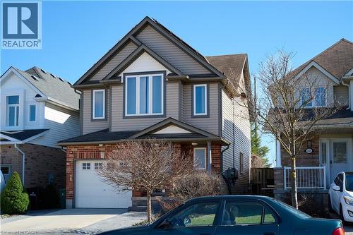 View of front of home with a garage, brick siding, and driveway - 126 Snowdrop Crescent, Kitchener, ON - Outdoor