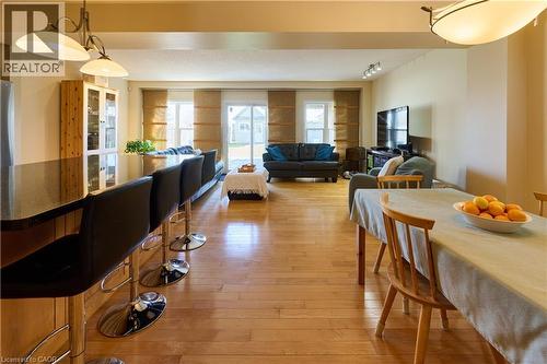 Dining area with light wood-style floors and rail lighting - 126 Snowdrop Crescent, Kitchener, ON - Indoor Photo Showing Dining Room