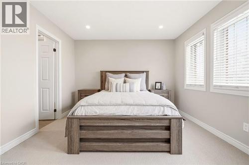 Bedroom featuring light colored walls, recessed lighting, and two windows with blinds providing natural light - 1 Tomahawk Drive, Grimsby, ON - Indoor Photo Showing Bedroom
