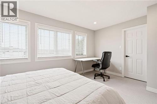 This room features carpeted flooring, light grey walls, and a recessed light fixture in the ceiling - 1 Tomahawk Drive, Grimsby, ON - Indoor Photo Showing Bedroom