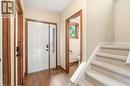 Inviting entryway featuring hardwood flooring, a white paneled door with a sidelight, and a carpeted staircase - 1 Tomahawk Drive, Grimsby, ON  - Indoor Photo Showing Other Room 