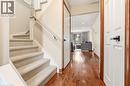 The property features a staircase with light-colored carpeted treads and a white banister, alongside rich hardwood flooring in the hallway - 1 Tomahawk Drive, Grimsby, ON  - Indoor Photo Showing Other Room 