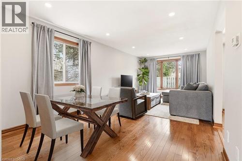 The property features a bright living area with hardwood flooring, recessed lighting, and large windows with privacy drapes - 1 Tomahawk Drive, Grimsby, ON - Indoor