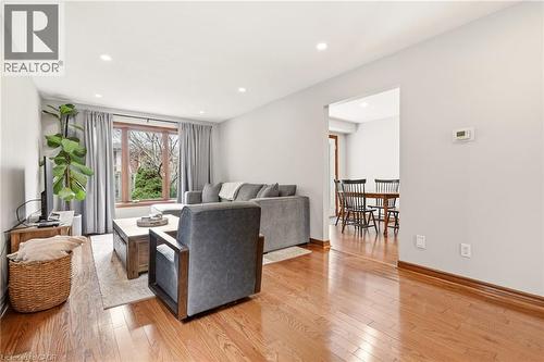 Living space featuring hardwood flooring, recessed lighting, and a large window with privacy curtains - 1 Tomahawk Drive, Grimsby, ON - Indoor