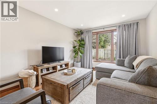 Living area featuring light-colored walls, recessed lighting, and a window with a view of outdoor greenery - 1 Tomahawk Drive, Grimsby, ON - Indoor Photo Showing Living Room