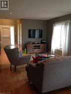 Living area with hardwood / wood-style floors and recessed lighting - 