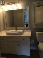 Half bathroom featuring vanity and dark tile patterned floors - 