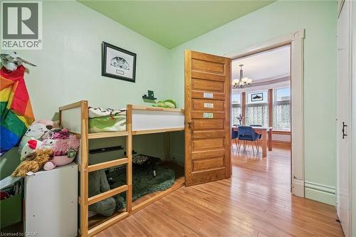 This room features hardwood flooring and a view into a dining area with bay windows - 155 Lancaster Street E, Kitchener, ON - Indoor