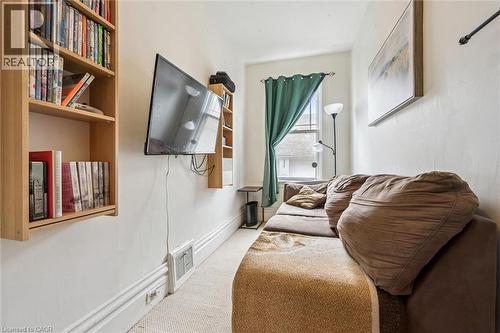 Den featuring a window with curtains, wall-mounted shelving, and a wall-mounted television - 155 Lancaster Street E, Kitchener, ON - Indoor Photo Showing Other Room