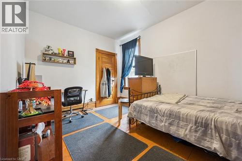 This room features light-colored walls and wood flooring - 155 Lancaster Street E, Kitchener, ON - Indoor Photo Showing Bedroom