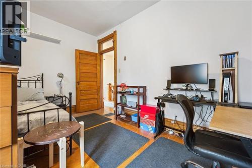 This room features light-toned hardwood flooring, a wood-paneled door, and a wooden shelf - 155 Lancaster Street E, Kitchener, ON - Indoor