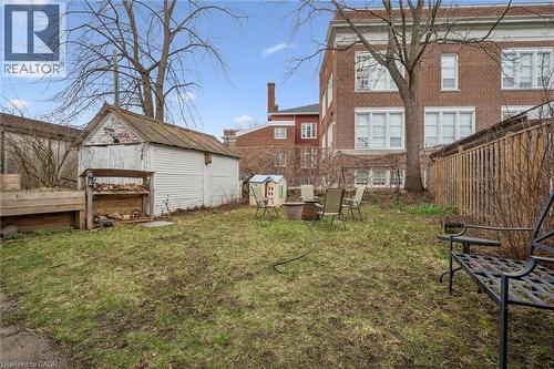 The property features a spacious yard with a storage shed and a wooden fence - 155 Lancaster Street E, Kitchener, ON - Outdoor