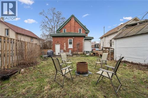 The property features a brick exterior with a green roof and white trim - 155 Lancaster Street E, Kitchener, ON - Outdoor With Exterior