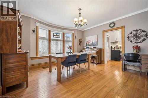This inviting room features polished hardwood flooring and light gray walls with white crown molding - 155 Lancaster Street E, Kitchener, ON - Indoor Photo Showing Dining Room