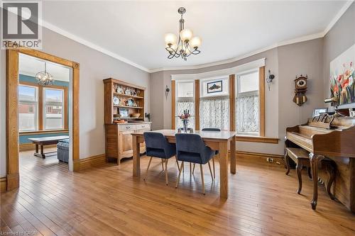 This dining area features hardwood floors, a bay window, and a chandelier - 155 Lancaster Street E, Kitchener, ON - Indoor Photo Showing Dining Room