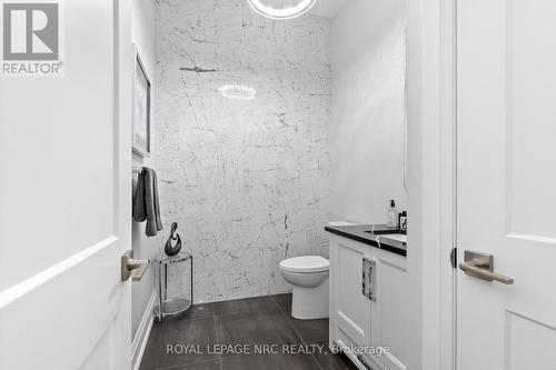 Boutique 2-p powder room with gold-fleck tile wall - 18 - 190 Canboro Road, Pelham (Fonthill), ON - Indoor Photo Showing Bathroom