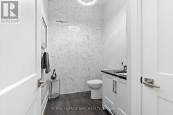 Boutique 2-p powder room with gold-fleck tile wall - 