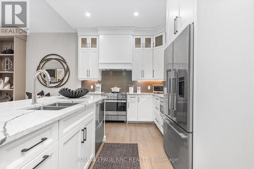 Upper display cabinetry - 18 - 190 Canboro Road, Pelham (Fonthill), ON - Indoor Photo Showing Kitchen With Double Sink With Upgraded Kitchen