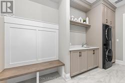 Laundry with custom cabinetry and folding bench - 