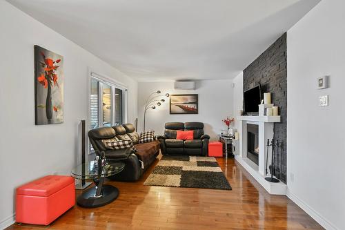Living room - 3200 Rue Des Monarques, Longueuil (Saint-Hubert), QC - Indoor Photo Showing Living Room With Fireplace