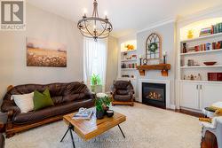 Living room with custom cabinetry and a fireplace - 