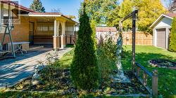 View of the gardens, back patio and carport - 