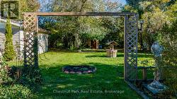 Landscaped back yard with gardens and mature trees - 