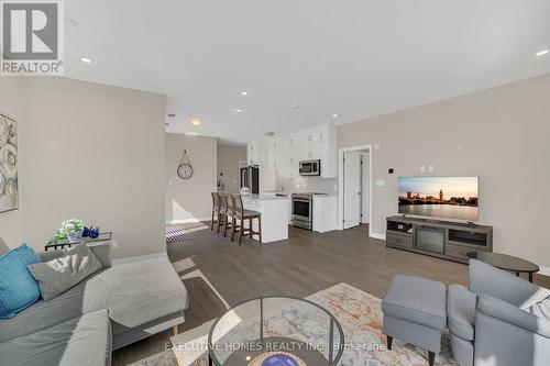 208 - 3265 Carding Mill Trail, Oakville, ON - Indoor Photo Showing Living Room