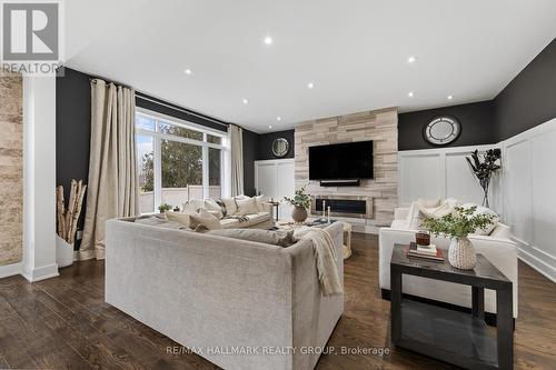 Family room adjacent to the kitchen - 91 Shaughnessy Crescent, Ottawa, ON - Indoor Photo Showing Living Room With Fireplace