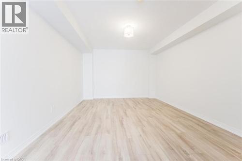 This room features light-colored plank flooring, white walls, and a ceiling light fixture - 686 Benninger Drive, Kitchener, ON - Indoor Photo Showing Other Room