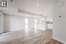 The open concept living area features light wood-style flooring, white walls, recessed lighting, and large windows providing ample natural light - 686 Benninger Drive, Kitchener, ON  - Indoor 