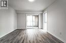 Room featuring light-colored walls, wood-look flooring, and a sliding glass door leading to a balcony with metal railings - 686 Benninger Drive, Kitchener, ON  - Indoor Photo Showing Other Room 