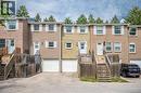 Brick exterior townhome featuring a front porch with wood railings and stairs - 212 Westcourt Place, Waterloo, ON  - Outdoor 