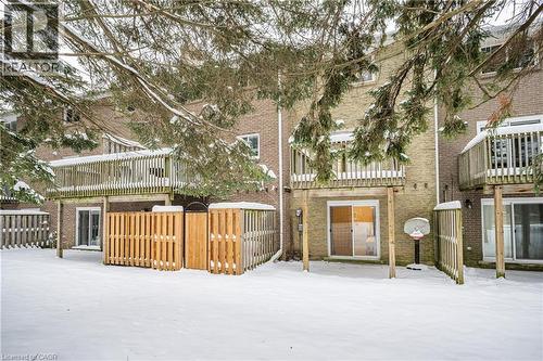 The property features a private deck overlooking a fenced yard - 212 Westcourt Place, Waterloo, ON - Outdoor