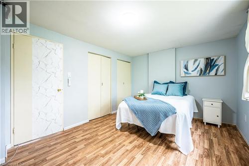 Wood-finish flooring with light blue walls and a white ceiling - 212 Westcourt Place, Waterloo, ON 