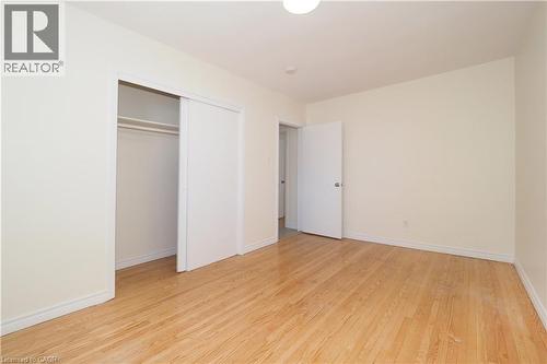 This room features hardwood floors and light-colored walls, creating a bright and airy atmosphere - 24 Austin Drive, Waterloo, ON - Indoor Photo Showing Other Room