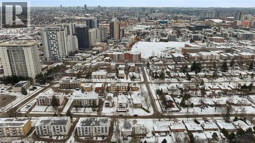 Aerial view of the surrounding urban landscape, showcasing a mix of residential properties with snow-covered rooftops and streets - 24 Austin Drive, Waterloo, ON - Outdoor With View
