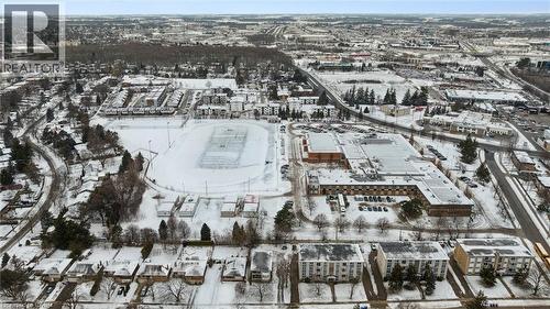 Aerial view of the neighborhood showcasing surrounding residential properties, commercial buildings, and a large recreational field - 24 Austin Drive, Waterloo, ON - Outdoor With View