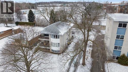 The property features a multi-story building with a grey shingle roof and a prominent bay window design on one facade - 24 Austin Drive, Waterloo, ON - Outdoor