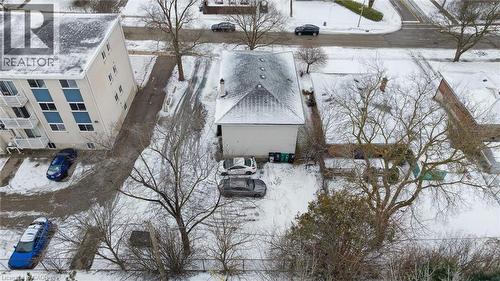 The property features a peaked roof and an expansive driveway with space for parking - 24 Austin Drive, Waterloo, ON - Outdoor