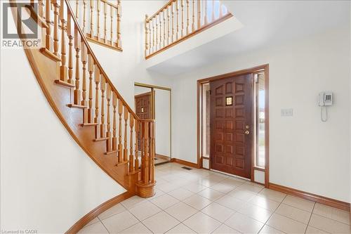 The property features a grand entryway with a hardwood staircase and a tiled floor - 18 Marcel Place, Hamilton, ON - Indoor Photo Showing Other Room